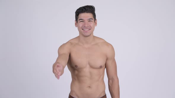 Happy Young Handsome Muscular Shirtless Man Giving Handshake