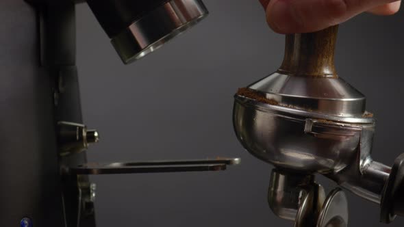 Man Hand Stuffing Coffee to Portafilter Close Up