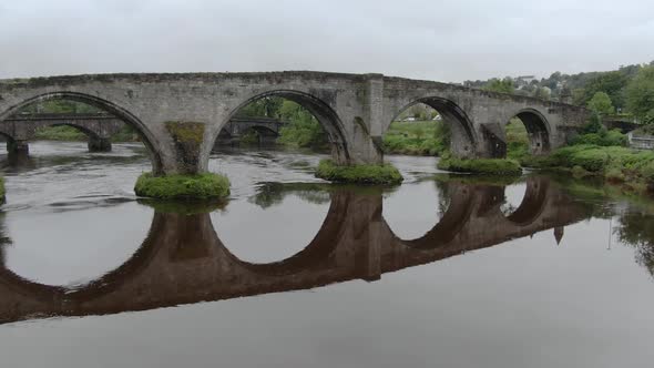 Slow motion, flying under Stirling Old Bridge in Scotland.