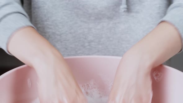 Washing Green Towel in Basin with Froth and Washing Powder Closeup Using Detergent for Spoiled Dirty