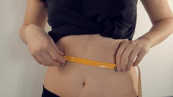 Woman Measuring Waist Progress Weight Loss. Girl Measuring Waist With Measure Tape. Measuring Tape.