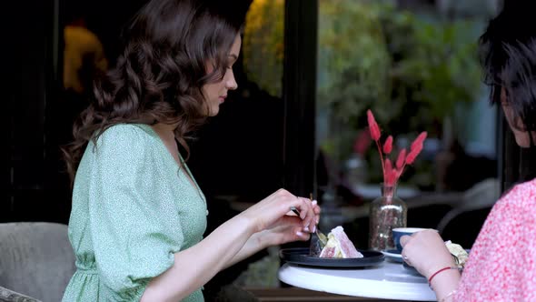 Mother and Daughter are Talking While Sitting at the Table