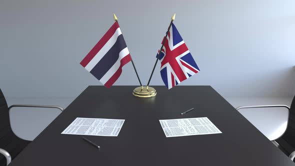Flags of Thailand and the UK and Papers on the Table alt