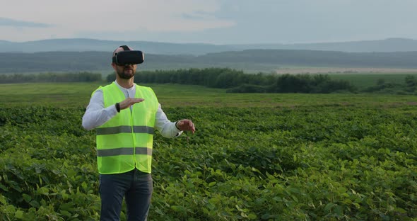 Farm Specialist Engineer Using Technology VR Monitoring Harvest Working for Agriculture Productivity