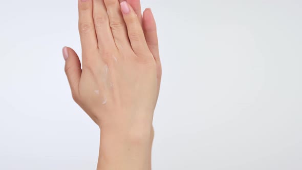 Woman Applying Cosmetic Hand Cream on Hand