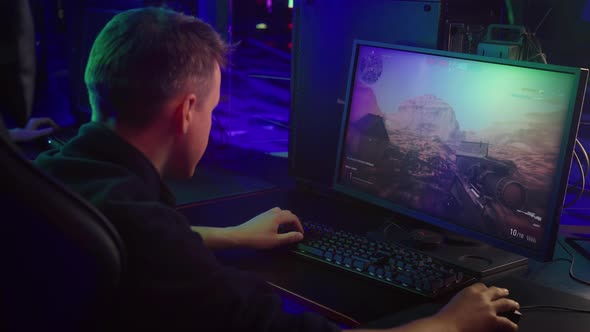 Young Gamer Boy Focused On A Personal Computer Gaming Activity At E-sport Club alt