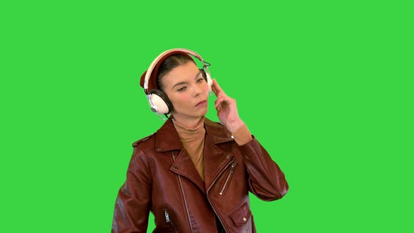 Rocker Girl Listening to Music in Headphones on a Green Screen Chroma Key