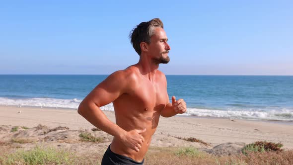 Athletic Man Exercising At The  Beach