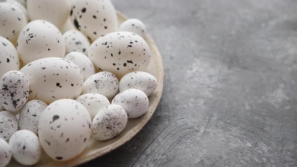 Composition of White Traditional Dotted Easter Eggs in White Ceramic Plate