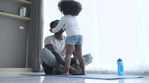 Asian-African American father and son relaxing and listening to music together