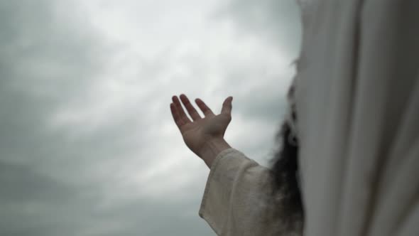 Religious Man Lifts Hand Praying