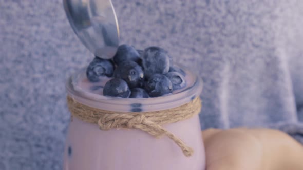 Bowl with Yogurt and Blueberries on Table