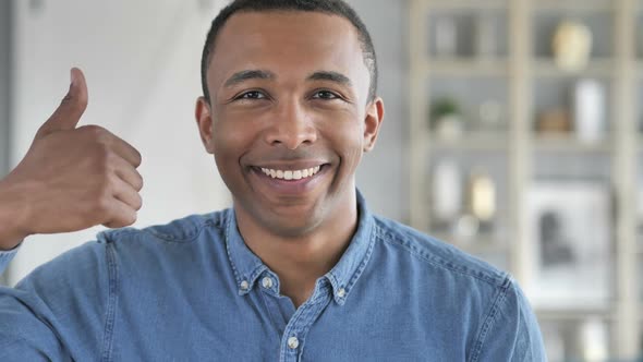 Thumbs Up By Young African Man Looking at Camera