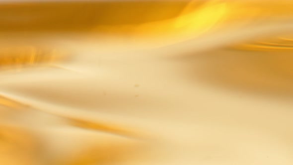 Super Slow Motion Abstract Shot of Waving Golden Oil Background at 1000Fps