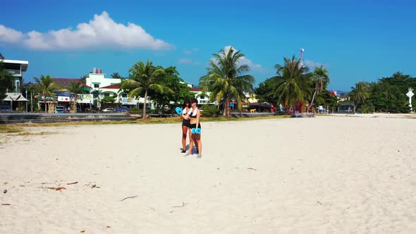 Girls look beautiful on beautiful tourist beach lifestyle by blue water with white sandy background 