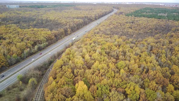 Aerial View of Road Between Forests in Countryside