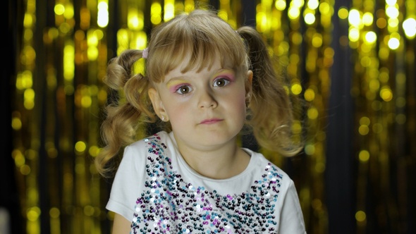 Stylish Child Dancing Fooling Around, Make Faces, Girl Posing on Background with Foil Golden Curtain