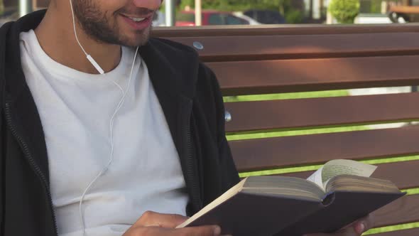 The Handsome Man Turns Over the Pages and Reads the Book