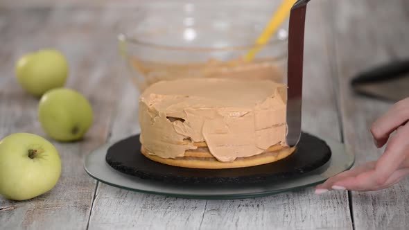 The Process of Decorating a Cake with Caramel Cream Cover.