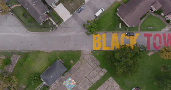 Bird eye view of a large "Black Towns Matter" sign painted on street in Houston Historical independe