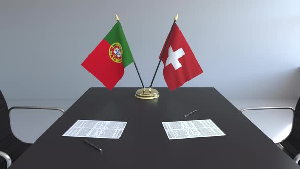 Flags of Portugal and Switzerland and Papers