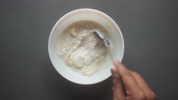 Oats Banana and Milk in a Bowl on Black Background