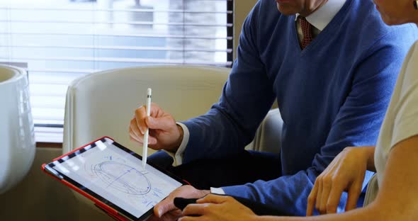 Optometrist discussing over graphic tablet with patient 4k