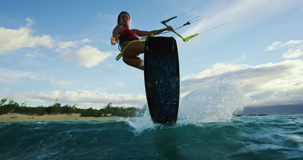 Woman Kiteboarding at Sunset