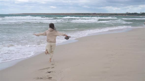 Young Woman on the Beach in the Storm