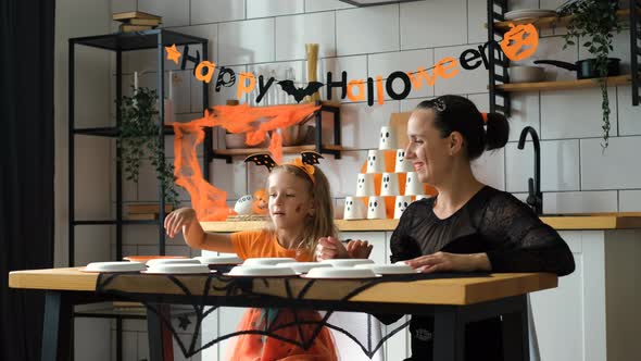 Woman with Daughter Playing Halloween Memory Game