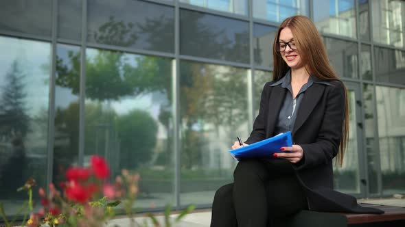 Businesswoman Hand Signing Contract with Pen