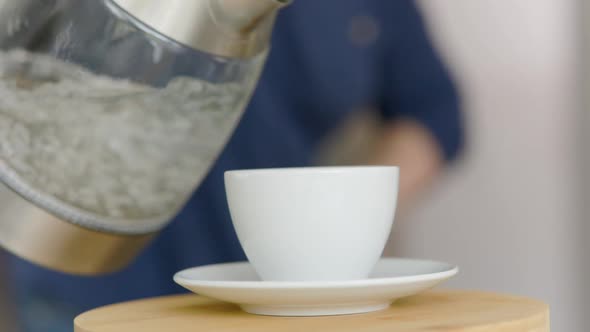 Boiling Water Is Poured Into A Cup Of Coffee And Steam Is Going The Camera Moves