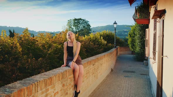 Gorgeous Blonde Woman Enjoying the Sun Rays in Summer