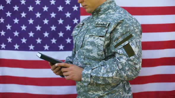 Sergeant Reading Bible With American Flag Behind, Religion Support, Spirituality
