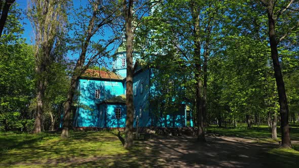 Old Wooden Church Painted with Blue Paint Aerial Firstperson View