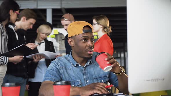 Concentrated Afro American Man in Casual Clothing Working on Computer