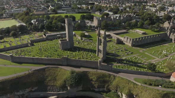 Aerial drone view of the St Andrews Cathedral and cemetery grounds in Scotland, UK. ESTABLISHING, DE