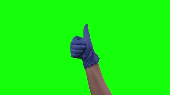 Doctors Female Hand in Blue Glove Is Holding Thumb Up Making Gestures Like. Green Screen. Close Up