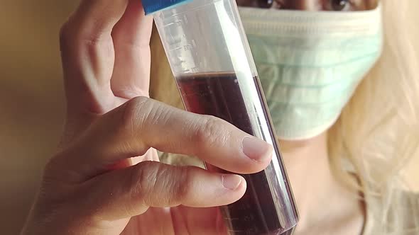 Woman Holding a Test Tube