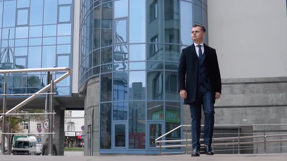 A Businessman in a Suit Walking Through the Business Center. Slow Motion