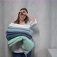 A Young Housewife Woman Holds a Stack of Fresh Washed Clean Linen in Her Hands - VideoHive Item for Sale