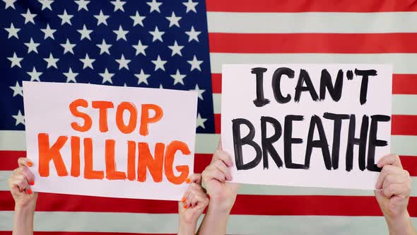 Protesters Hold Banners with Slogans - Stop Killing. I Cant Breathe - Against Background of the USA