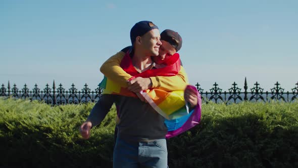 Loving Gay Wrapping His Male Lover with Pride Flag