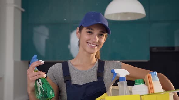 Beautiful Woman with Cute Smile from Cleaning Service Standing in the Contemporary Cuisine