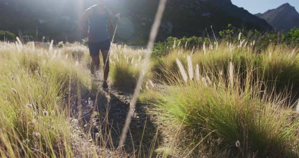 African american man cross country running in countryside on a mountain