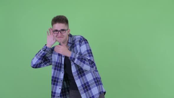 Happy Young Hipster Man Listening While Laughing