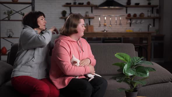 Mother Combing Hair of Her Child on Sofa