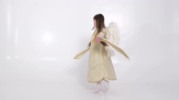 Little Girl with Angel Wings Dancing on a White Background