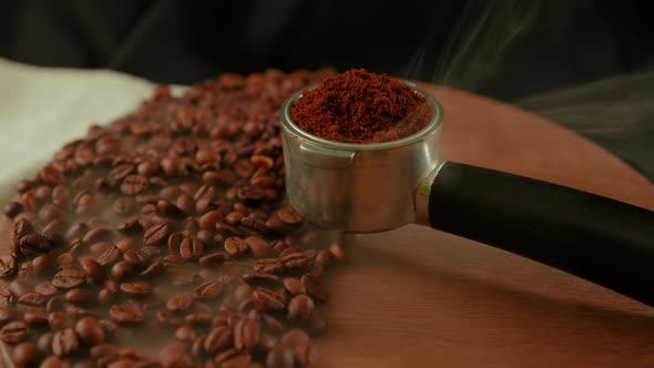 Ground Coffee in Portafilter on Wooden Board with Coffee Beans and Dissipating Steam