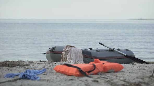 Abandoned Boat, Lifejacket and Clothes on Beach, Swimming Injury Statistics